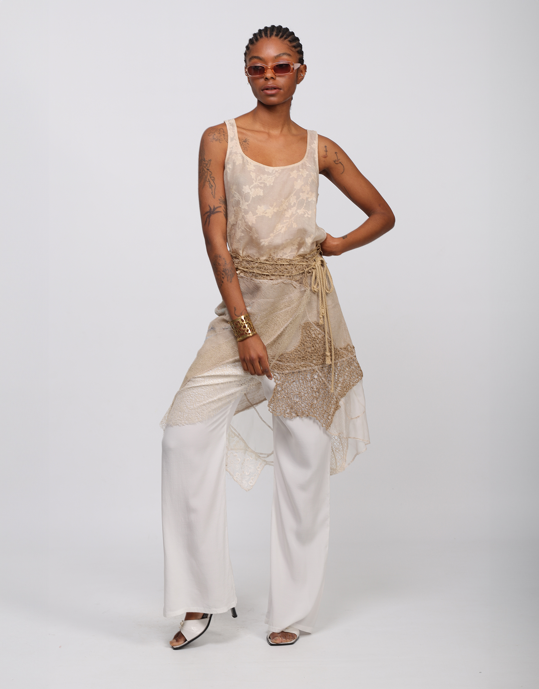 Wrap skirt in beige, ivory embroidered patchwork mesh and knitted string