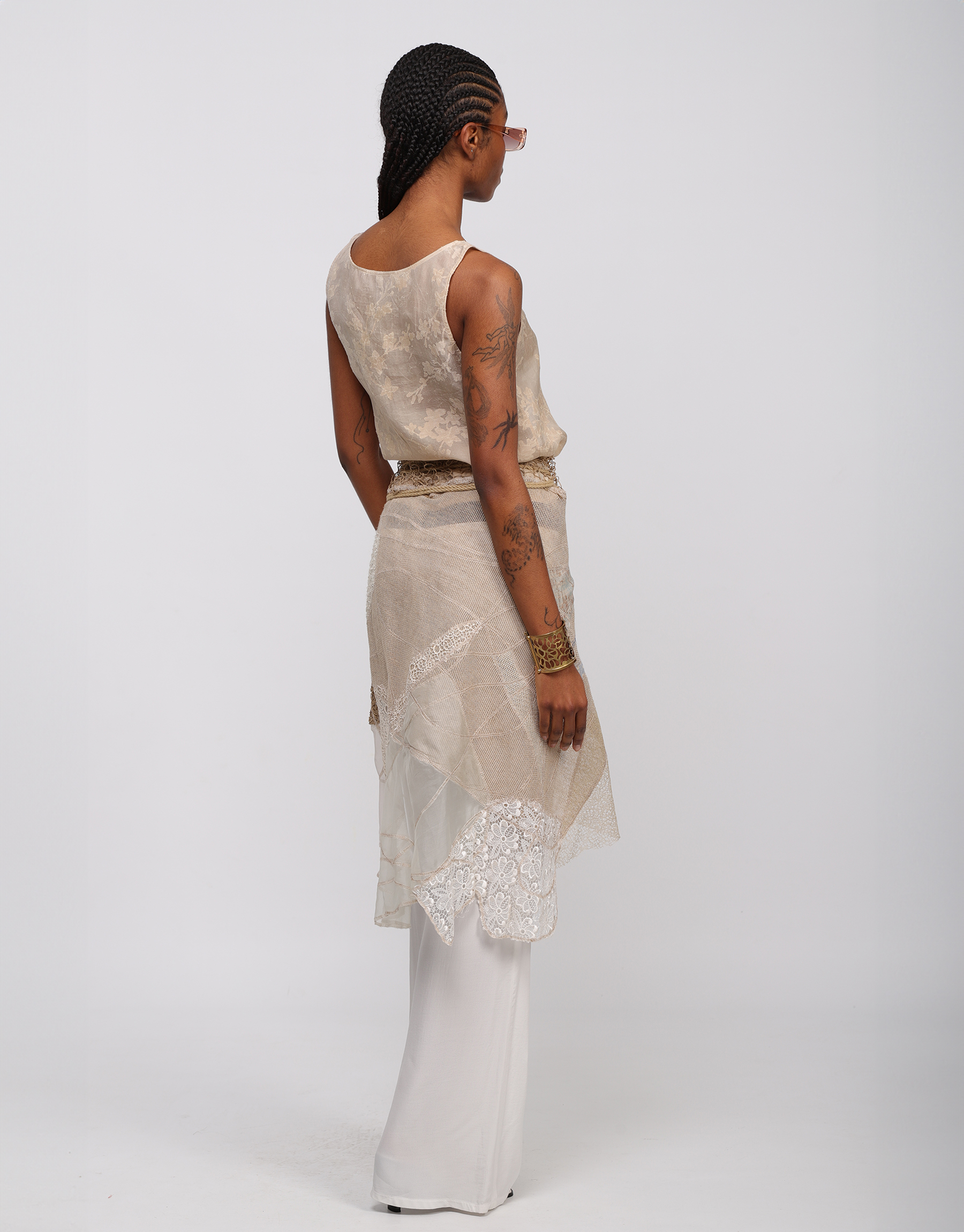 Wrap skirt in beige, ivory embroidered patchwork mesh and knitted string